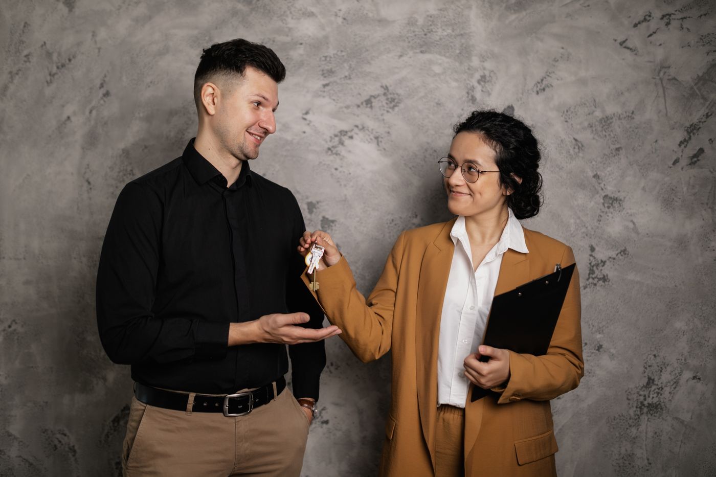 A property professional handing keys to a new resident